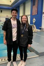 MWHS Diving Coach Patrick Capriglione stands with swim champ Molly Crowley.