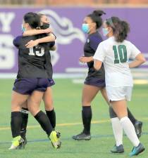 Julia Tycott and Alexis DeLeo celebrate the first goal of the season. Photos by William Dimmit.