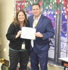Suzanne Adler receives her Citizen of the Month certificate from County Executive Steve Neuhaus.