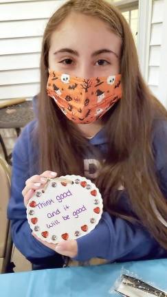 CTeen Leader Samantha Hamel decorates a tile and writes a message of hope for sick children at Chabad’s CTeen giving event “Tiles for Smiles.”