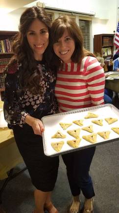 Chana Burston of Chabad of Orange County, pictured (left) with Heather Greenberg of Monroe holding her oven-ready cookies, will lead two Hamantash workshops on Feb. 25.