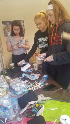 Chabad of Orange County CTeen chapter members assemble 17 packages they will personally deliver to homeless people in New York City, an act of kindness to honor of the 17 victims of Parkland (Photos courtesy of Rabbi Pesach and Chana Burston/Chabad Orange)