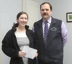 Monroe-Woodbury High School senior Kathryn Nicoll accepts a Certificate of Merit from the National Merit Scholarship Program from Principal John Kaste. Nicoll is among the finalists for the prestigious scholarships.