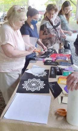 Participants of Chabad’s Jewish Women’s Circle choose designs to create a Judaic Keepsake as they learn the art of glass etching.