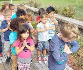 The young members of Andrea Abrignani’s class at the St. Paul Christian Education Center in Monroe pray for their country, their community and their families. Photo provided by Ramona Adams.