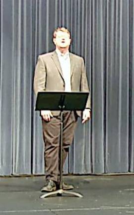Middle School Chamber Chorus teacher Brian Clark performs a song from “Camelot.”