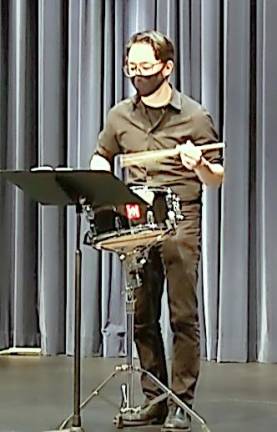 Middle School band teacher Adam Conforti performing snare drum solo.