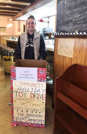 Alexandra Maynard, a member of the National Honor Society at George F. Baker High School in Tuxedo, delivers a Toy Drive box to The Orange Top Diner in Tuxedo Park.