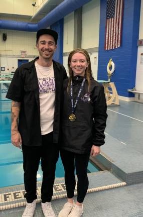 MWHS Diving Coach Patrick Capriglione stands with swim champ Molly Crowley.