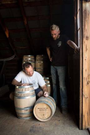 Photos by Sally Sosler Photography Bryan Ensall and John Glebocki working on a bourbon whiskey barrel.