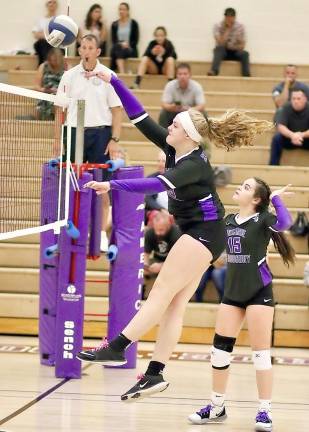 Jammie Waldron spikes a shot over the net in the last set.