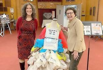 In honor of Tu Bishvat, Monroe Temple celebrated its first sustainable Shabbat on February 7. Pictured are Diane Rowe and Natalie Browne with a display highlighting that in one year one shopper can use 500 single-use plastic bags.