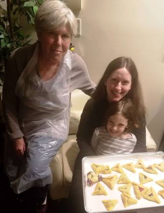 Three generations of Hamantash bakers: Sheryl Kerewski of Goshen, left, and her daughter Michelle Sentell and granddaughter Heather of Monroe proudly display their hamantashen at a Chabad workshop.