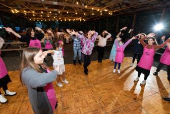 As the dough rose, participants danced and sang to lively music in celebration at Chabad’s Pink Mega Challah Bake with Israeli dancing led by Limor Einav and Marcella Lejovitzky, of Curves Gym, Monroe.