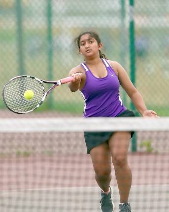 Emma Cherian returns serve in the second set of her singles match.