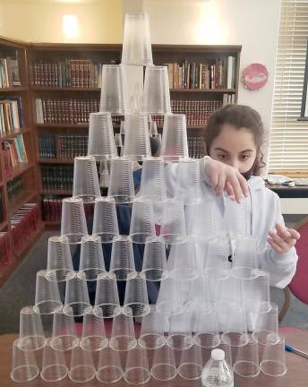 Yasmine Mosker of Monroe learned about the Jews’ slavery in Egypt by building pyramids with plastic cups of at Chabad Hebrew School.