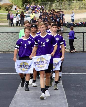 Members of the football and the boys and girls soccer teams are led on to fields for the first time by Tyler Koblish, Petro Klish and Jesse Schwartz.