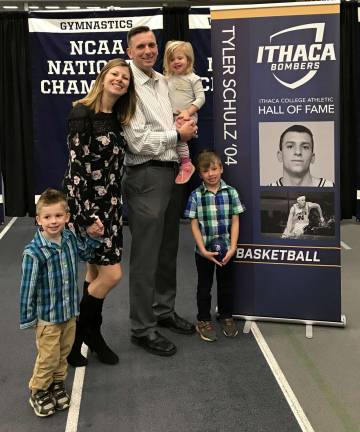 Since graduation from Ithaca College, Tyler Schulz has been with the New York City Fire Department. He is pictured here with his family following his induction last month into the Ithaca College Athletic Hall of Fame for basketball.
