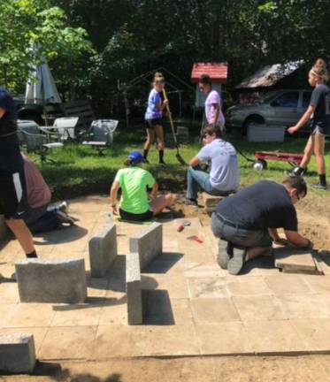 The young missionaries from St. Paul Lutheran Church in Monroe helped build a stone patio walkway for an elderly couple living in a trailer.
