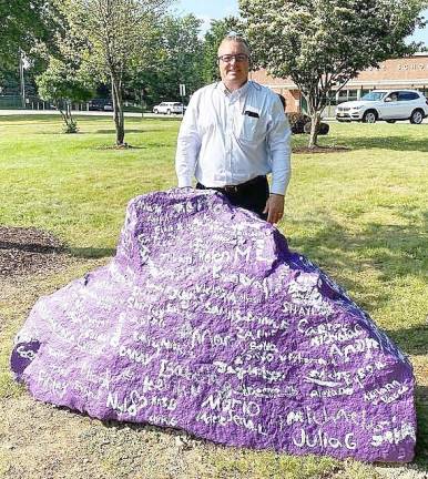 Pine Tree Bryan Principal Giudice with the painted 1.5 ton boulder signed each and every 5th grader. Next year, it will be painted over and a new group of graduates will sign their names. And so the tradition will go.