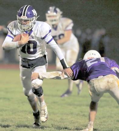 Quarterback Anthony Campione gets past a Wildcat defender in the fourth quarter.
