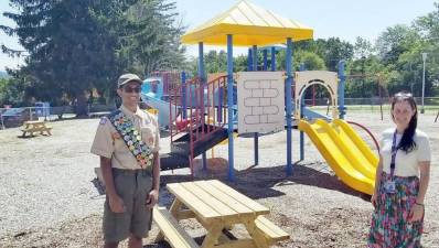 Troop 440 Eagle Scout candidate Rahul Raja is joined by Sapphire Elementary Principal Caitlin Caldwell at the school’s playground. Rahul built and delivered picnic tables and benches for the school where he went for kindergarten. Provided photo.
