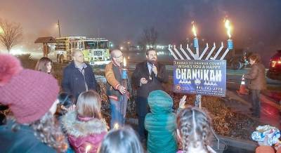 Last year's Menorah Lighting in Monroe: Pictured from left to right are Chana Burston, Monroe Town Supervisor Tony Cardone, Monroe Village Mayor Neil Dwyer and Rabbi Pesach Burston. This year's lighting takes place Sunday, Dec. 20, beginning at 4:30 p.m.