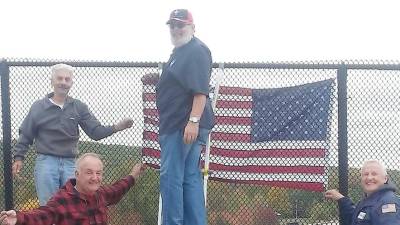 Installing flags on overpasses like Route 17 is one of the things Marty Currid, Kurt Haugh, Oscar Giusto and Jack Collins do to keep U.S. flag awareness and respect in the eyes of the community.