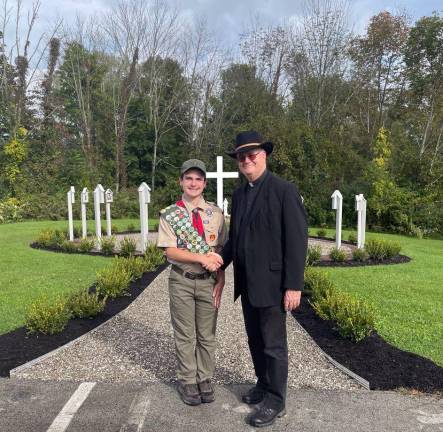 After: The Rev. Joseph Tyrrel, pastor of St. Patrick’s Church in Highland Mills, thanks Troop 440 Eagle Scout candidate Michael Kearney upon completion of a new prayer garden on the church property.