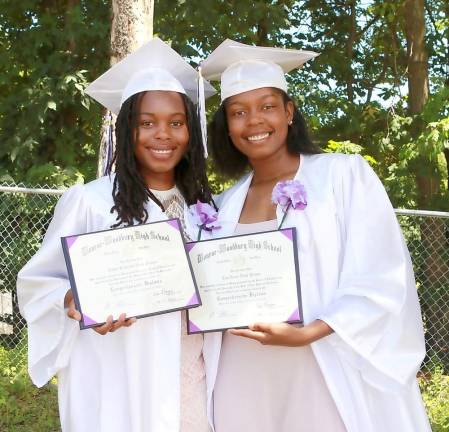 Taylor and Toni Neely show their class of 2020 diplomas.