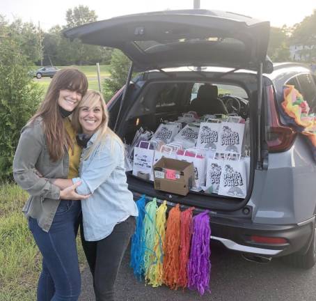 From left: Melissa and Adrienne Longo of Electric Love Studios filmed the prior day’s drag show at Tequila 55 in Dover, N.J. In the hatch are Morris County PRIDE goody bags for each car. (Photo provided by Simone Kraus)