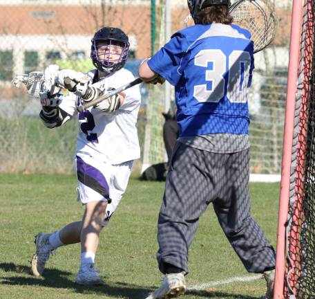 Bennett Smith (#2) has his eyes on the net before he scores in the fourth quarter.