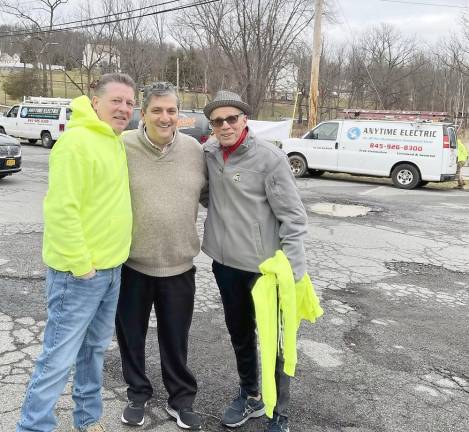 Washingtonville Mayor Joe Bucco is flanked by Anytime Electric owner Tim Doran, who donated the materials, and IBEW 363 head Sam Fratto, who brought in 18 union electricians to take part in this successful community service. Photos provided by Tim Doran.