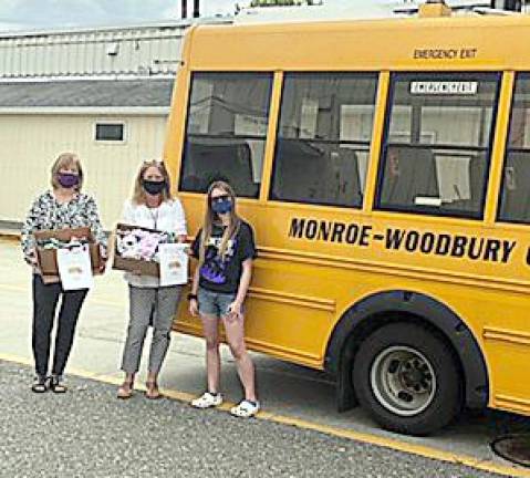 Samantha Larkin this past week presented the Monroe-Woodbury School District Bus Garage with more than 100 masks. The idea is bus drivers will keep masks onboard their buses and provide masks to children who forget to wear them to the bus stop.