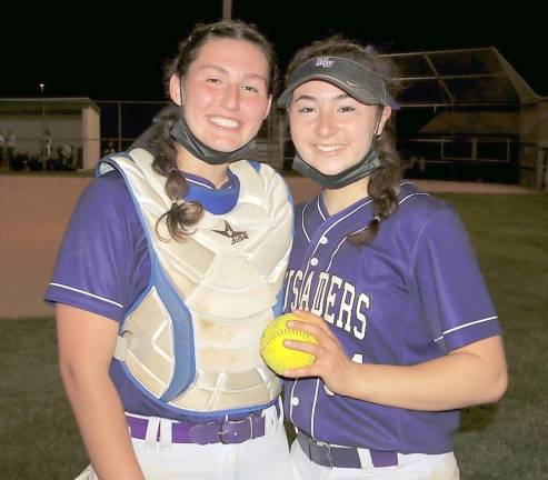 Emma Lawson (right) and Brianna Roberts (left) celebrate after Brianna’s perfect game last Friday night.