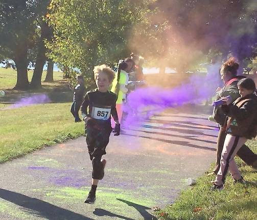 A young runner competes in the South Orange Family YMCA’s fifth annual 5K Color Run and Kids Dash last Saturday in Crank Park along the Mill Ponds.