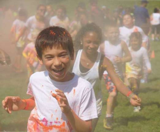 Photo provided by the South Orange Family YMCA Sean Rule of Chester leads a group of children during the South Orange Family YMCA's 5K Color Run and Kids Color Dash last Saturday, July 15.