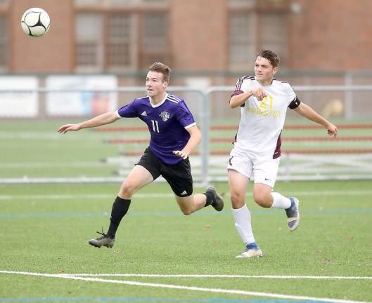 Owen Kelly (#11) drives the ball toward the Tigers' net in the first half.