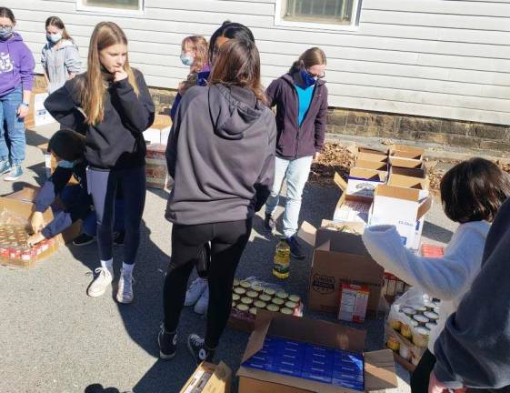 This past weekend Monroe-Woodbury Girl Scouts helped officials of the Monroe Food Pantry prepare Thanksgiving food boxes to needy families this Thanksgiving. Provided photos.