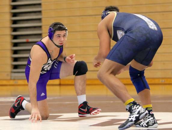 Nick McShea, at 220 lbs., pictured here on one knee, finished the streak when it took him 2:43 to pin Will McCartney.