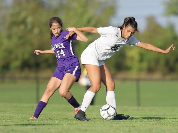 Ella Natal (#25) uses her body to shield the ball away from a Wildcat defender.