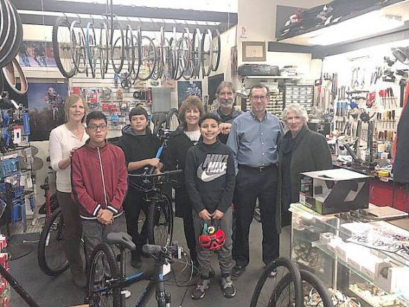 At the Bicycle Doctor in Middletown, from the left: Carol Kalajian, donation coordinator; bicycle recipients Jesus Carpinteyro and Juan Carpinteyro, Rosey Lawal, Northeast Gateway to Freedom pastor, Rich Cruet, Bicycle Doctor owner, bicycle recipient Mateo Sajous, Don Karlewicz, club treasurer and Peggy Cullen, president. Willy Bryan was also given a bike.