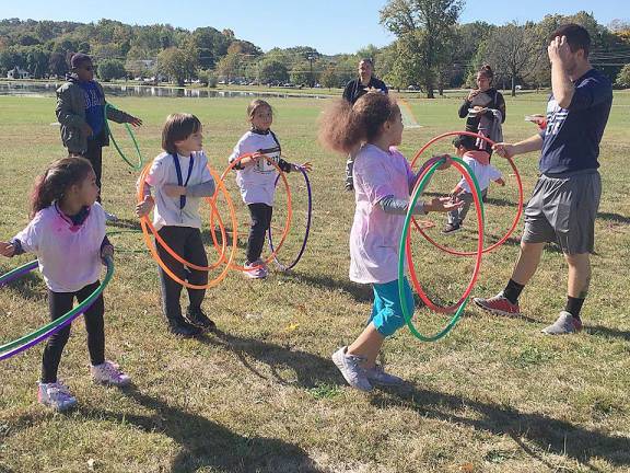 The Y led activities and games for the kids ,including sack races, spoon races, tug of war, soccer, dodge ball and hula hoops, led by Y Program Director Chase Alexander.
