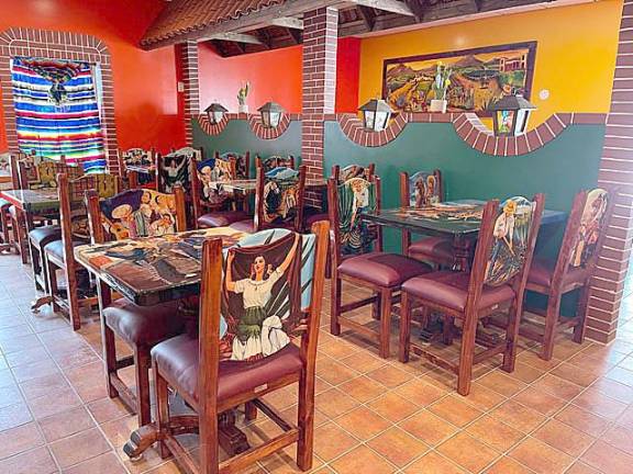 The restaurant and bar area are decorated with authentic colors and images of Mexico.