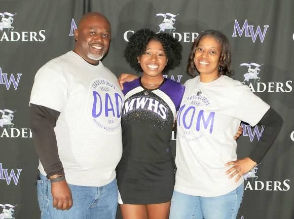 Senior cheerleader Kelli Gatling shares a moment with her parents Terrence and Cheri.