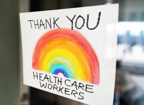 Healthcare workers child's painting hanging at window as appreciation support message for doctors and nurses fighting COVID-19 at hospitals.