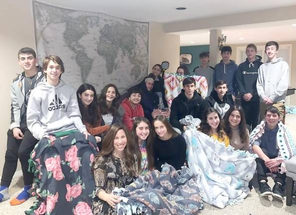 Teens from across Orange County gathered to create fleece blankets which will be donated to a local shelter.