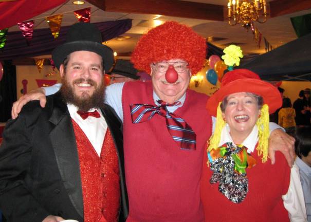 Rabbi Pesach Burston, director of Chabad of Orange County, pictured with Chabad President Gil and Phyllis Goetz at a previous Purim Gala, invites the community to a Superhero Purim Party on Feb. 28.