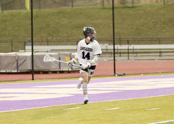 Carson Pesce, #14, brings the ball to the front of the net.