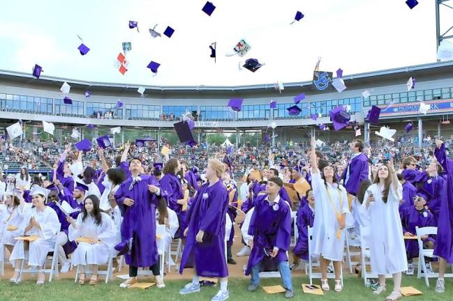 The moment: The Crusaders toss their hats into the air to celebrate their graduation last Friday, June 25, at the Palisades Credit Union Park in Pomona.